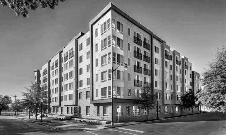 Multi-family housing in black in white on corner block.